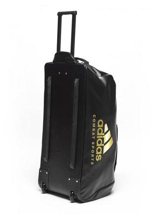 Спортивная дорожная сумка на колесах adidas combat sports с выдвижной ручкой обьем 120 литров из pu-кожи2 фото