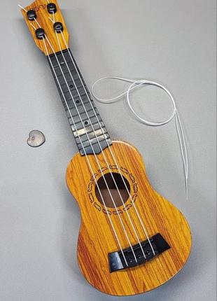 Детская маленькая гитара укулеле ukulele 4струны коричневая от 3х лет1 фото