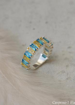 Серебряное кольцо дорожка с желтыми и голубыми камнями1 фото