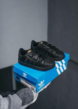 Детские кроссовки adidas superstar чёрные с золотым5 фото