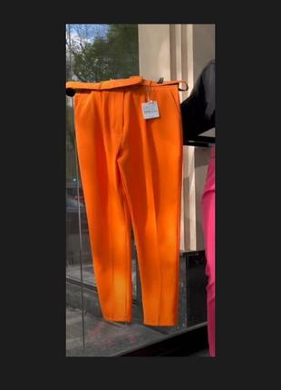 Оранжевые брюки высокая посадка.